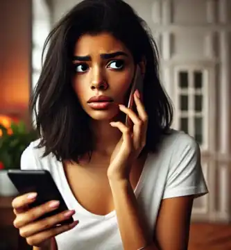 DALL·E 2024 06 23 13.21.36 A beautiful young woman with dark skin and black hair looking nervous as she receives a call. She is holding her smartphone and looking at it with a c