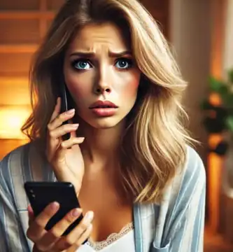 DALL·E 2024 06 23 12.35.42 A beautiful young woman with medium skin and blonde hair looking very worried as she receives a call. She is holding her smartphone and looking at it