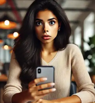 DALL·E 2024 06 23 12.49.49 A beautiful Latina young woman with dark skin and black hair looking nervous as she receives a call. She is holding her smartphone and looking at it w