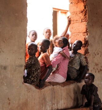 children sitting on window