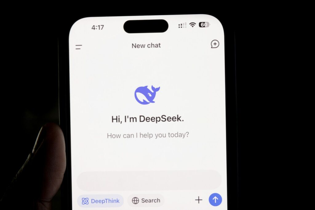 AI News DeepSeek A person holding a cell phone in their hand