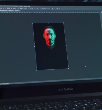 mejorar imagen con ia black lenovo laptop computer turned on displaying man in red shirt