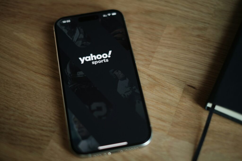 Yahoo A cell phone sitting on top of a wooden table