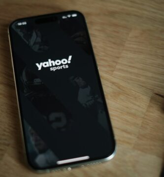 Yahoo A cell phone sitting on top of a wooden table