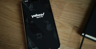 Yahoo A cell phone sitting on top of a wooden table