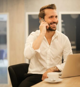 calling man using smartphone on chair