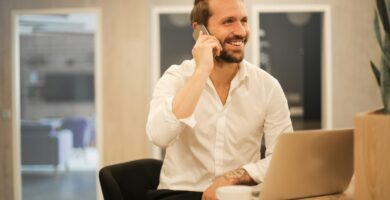 calling man using smartphone on chair