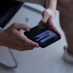 WhatsApp person holding black iphone 4