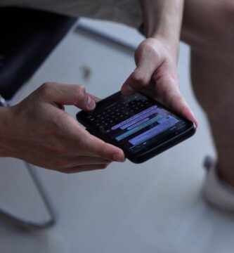 WhatsApp person holding black iphone 4